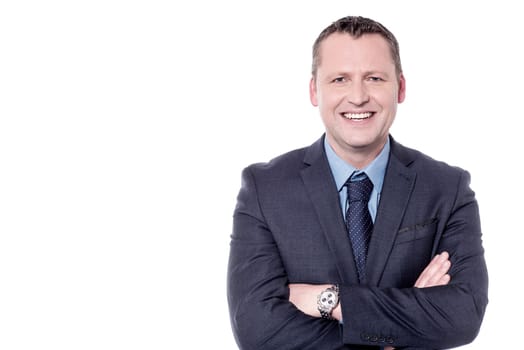Smiling male entrepreneur posing with folded arms