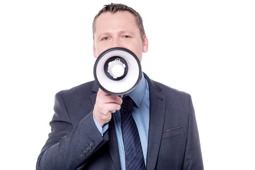 Businessman talking on a megaphone over white