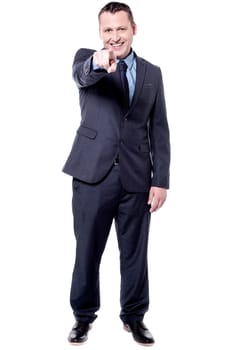 Handsome businessman pointing his index finger towards camera