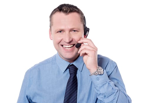 Smiling customer support executive talking over headphone