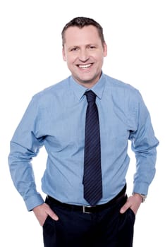 Handsome male executive posing with hands in pockets