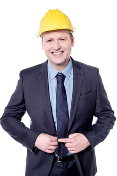 Smiling male engineer posing with yellow hardhat