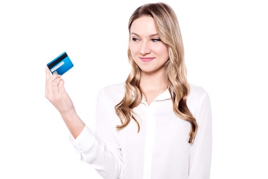 Attractive young woman holding credit card over white