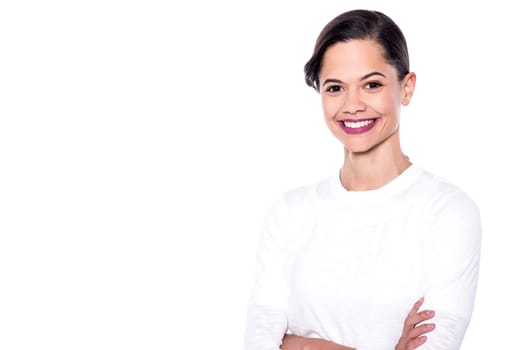 Happy young woman posing with crossed arms