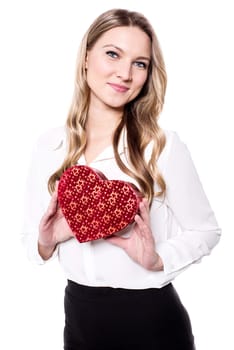 Young girl displaying her heart shaped gift box to camera