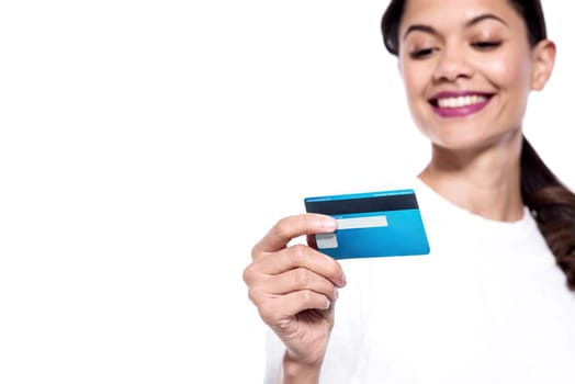 Smiling young woman checking her cash card