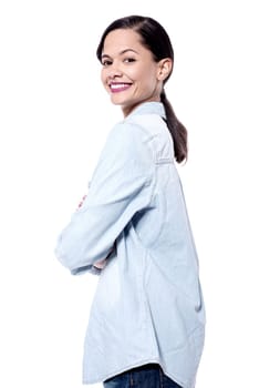Side pose of a young woman with crossed arms