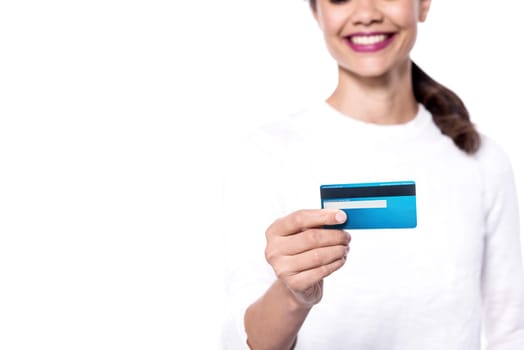 Cropped image of a young woman displaying her cash card