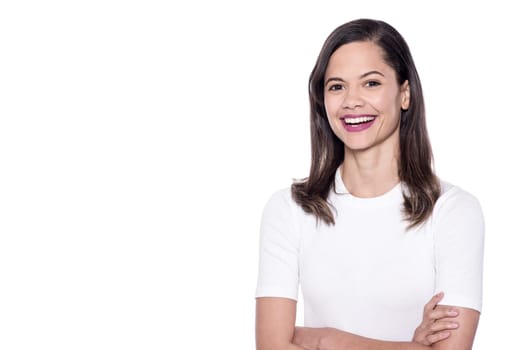 Young mixed race woman smiling at white background
