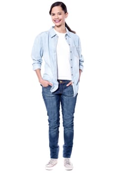 Full length picture of woman with hands in pockets