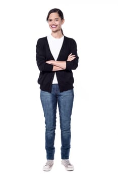 Woman in trendy wear posing with crossed arms