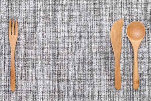 natural wooden spoon and fork, knife on tablecloth