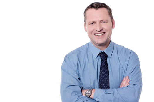Smiling male executive posing with folded arms