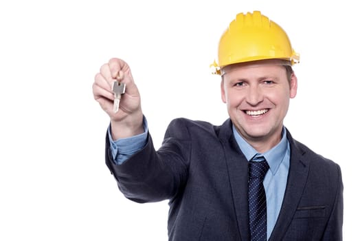 Happy male engineer giving new house key