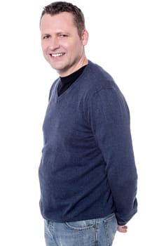 Side pose of casual man folding his hand at back
