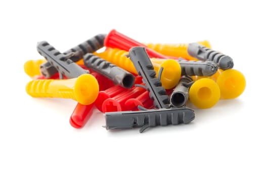 Closeup of colorful plastic dowels isolated on white background.