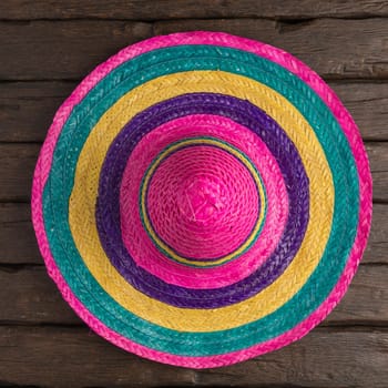 Mexican sombrero on old dark wood background.