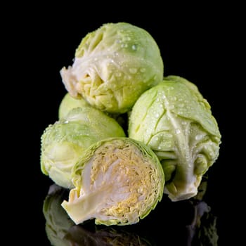 Fresh brussels sprouts isolated on black background.