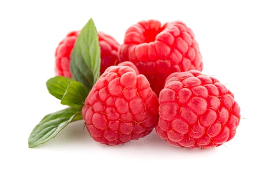 Raspberries with leaves isolated on white background