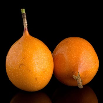 Passion fruit maracuja granadilla on black background.