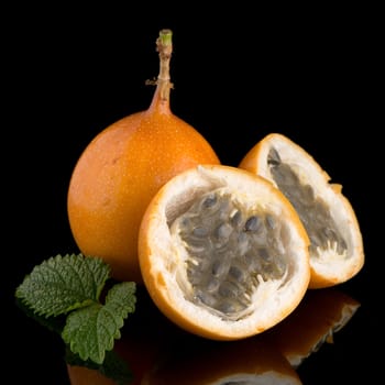 Passion fruit maracuja granadilla on black background.