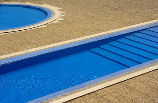 swimming pool blue water in a summer day