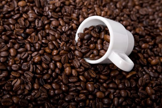 coffee beans and a white coffee cup