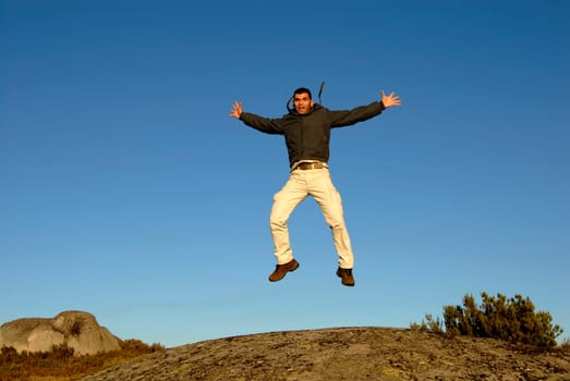 young man jumps high in the mountain
