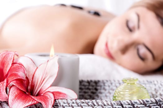 A beautiful woman lying during a stone therapy