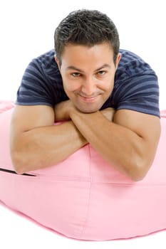 young casual man seated in a small sofa