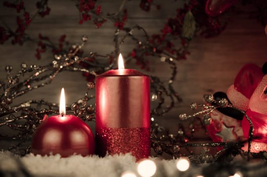 Two candles decorated in a festive Christmas decoration.