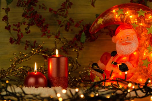 Two candles decorated in a festive Christmas decoration.