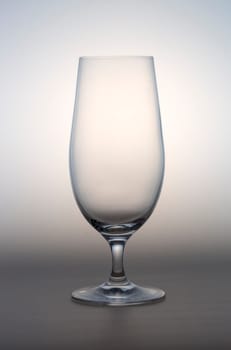 Empty Beer Glass on Grey and White background.