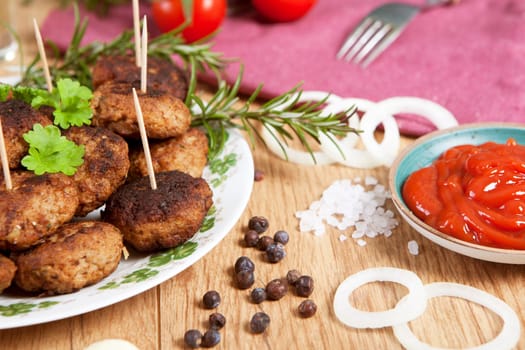 homemade bullets on a plate served with various ingredients on a wooden table