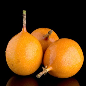 Passion fruit maracuja granadilla on black background.