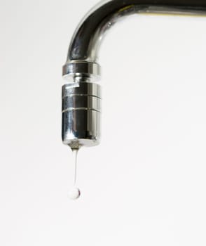 Water Dropping from Water Faucet close up.