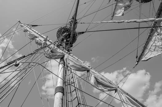 Mast with sails of an old sailing vessel, black and white photo
