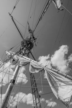 Mast with sails of an old sailing vessel, black and white photo