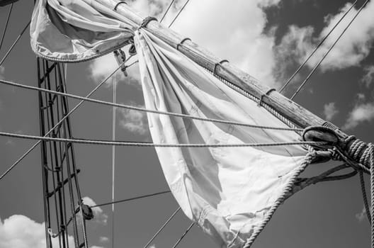 Mast with sails of an old sailing vessel, black and white photo