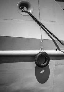 Car tire hanging off the side of the ship