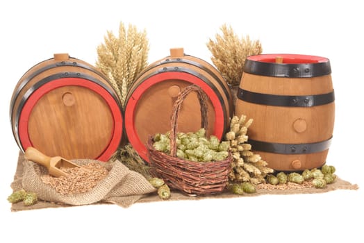 three old beer barrels insulated with wheat,barley,hops and malt On White