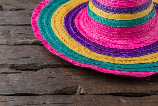 Mexican sombrero on old dark wood background.
