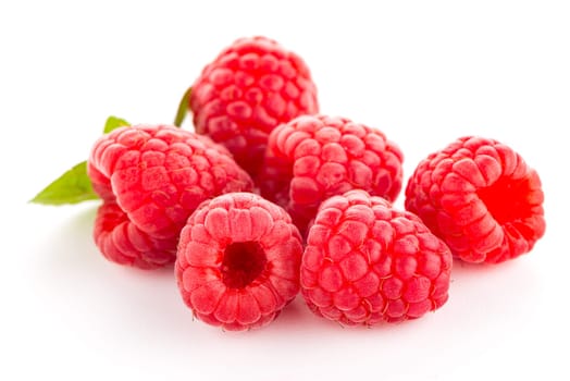 Raspberries with leaves isolated on white background