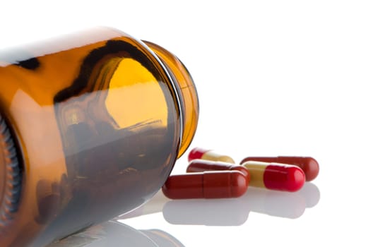 Pills from bottle on the white background.