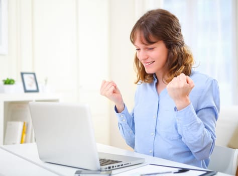 View of a young happy business woman at work
