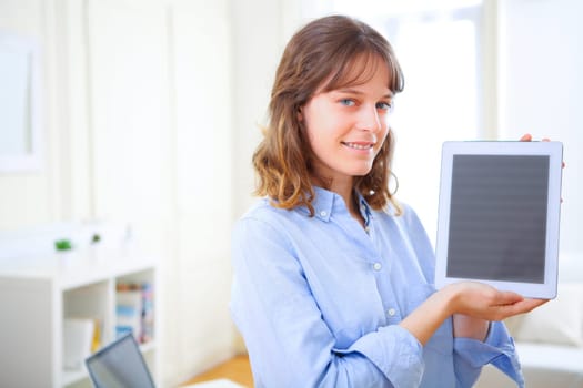 View of a young business woman showing a tablet screen