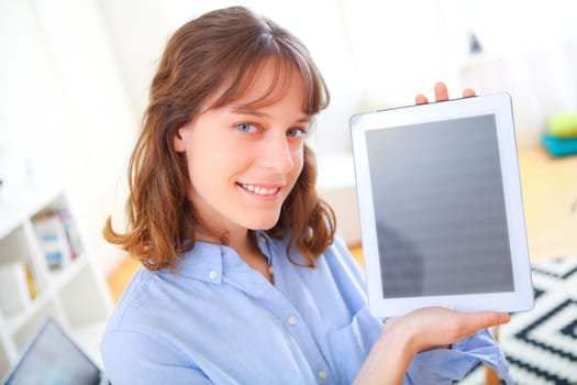 View of a young business woman showing a tablet screen