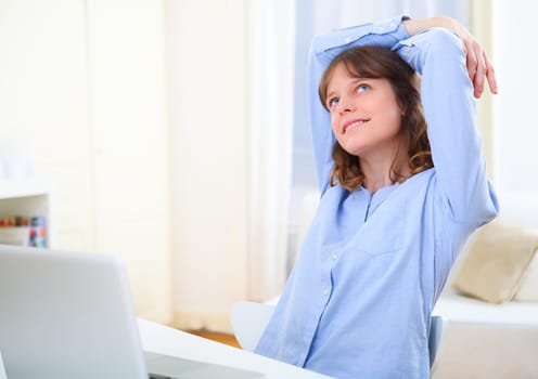 View of a young smiling business woman relaxing at work