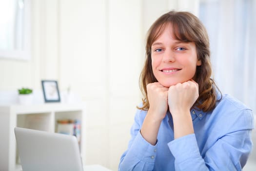 View of a young smiling business woman at work