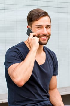 Young man on the phone in the city